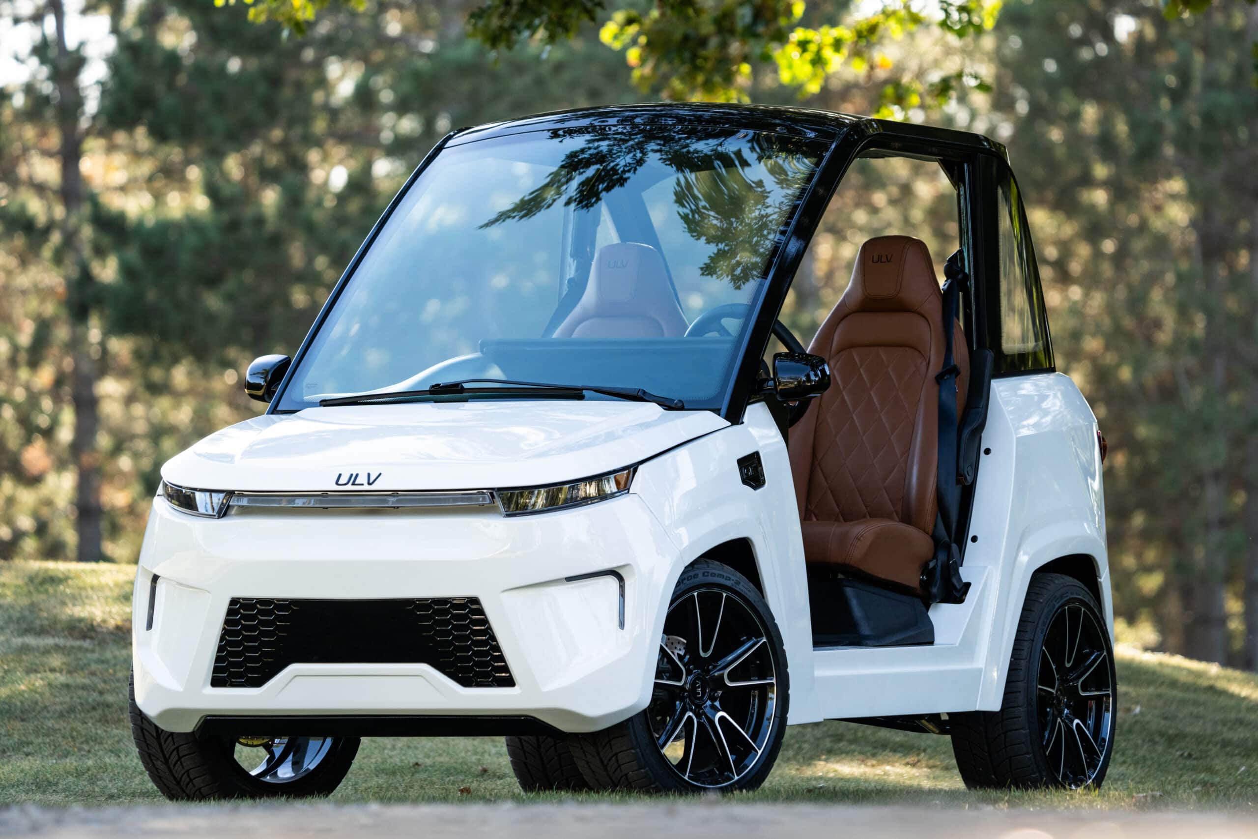 ULV 322 in white parked on a trail surrounded by trees